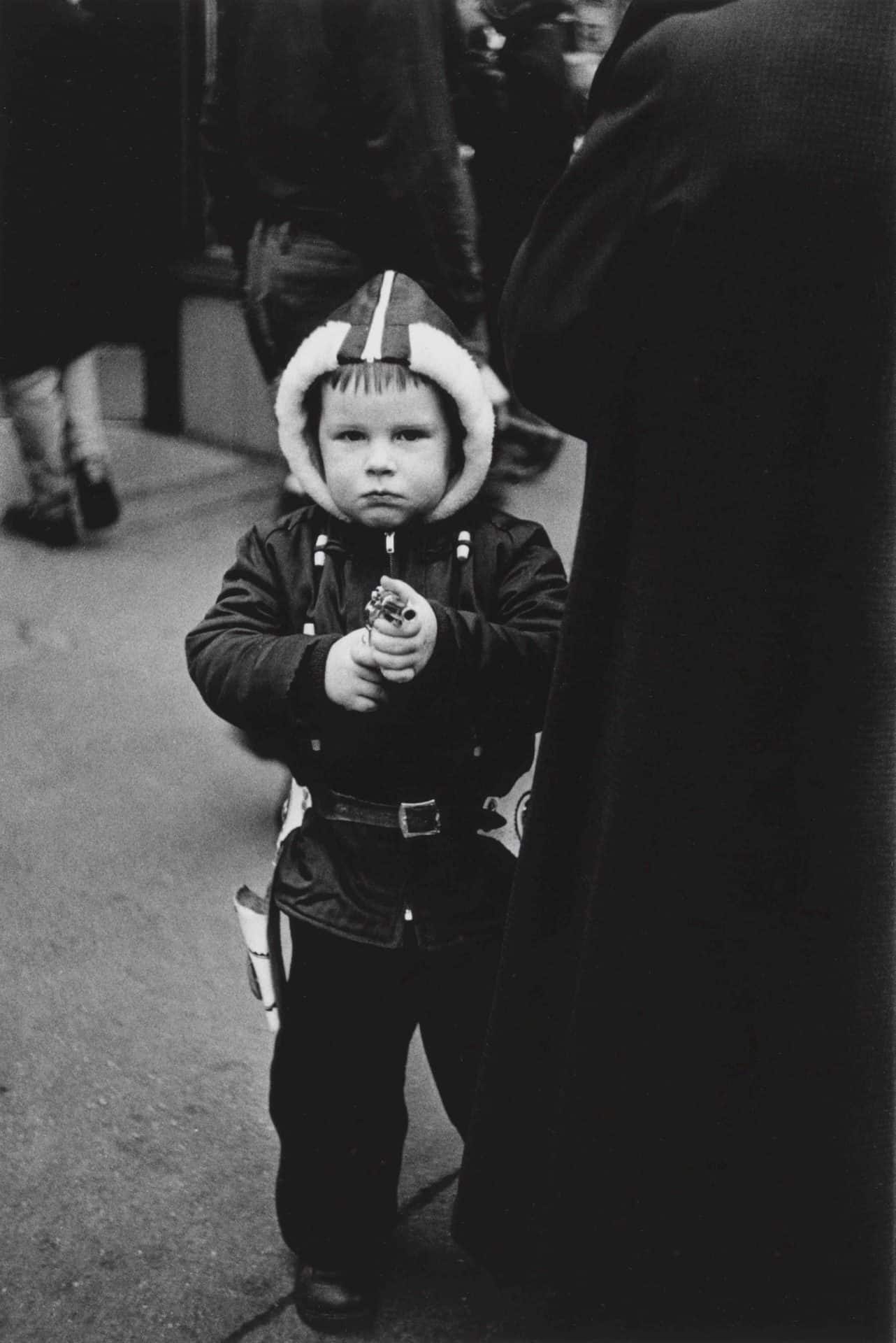 Diane Arbus. Kid in a hooded jacket aiming a gun, N.Y.C. 1957 ©The Estate of Diane Arbus, LLC. All rights reserved.