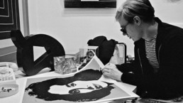 Andy Warhol signing a print, 1965.