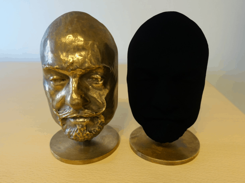 Two identical busts. One coated in Vantablack. Blackest black
