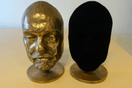 Two identical busts. One coated in Vantablack
