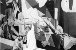 Museum of Modern Art Employees clen spray paint off of Guernica