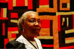 Mary Lee Bendolph in front of one of her quilts