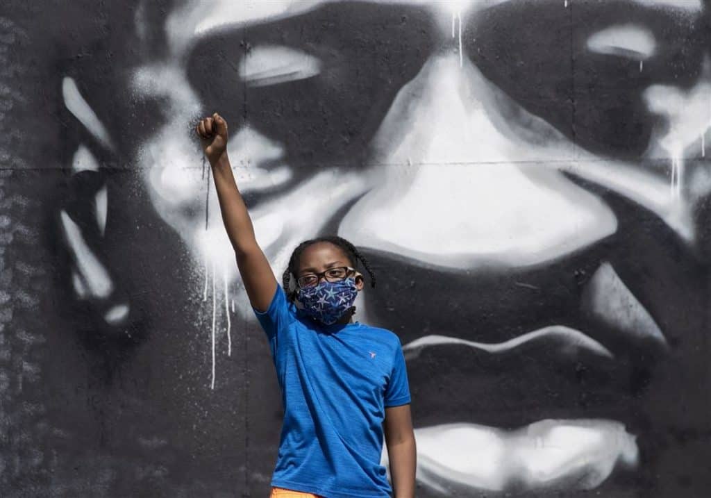 A child in front of George Floyd mural, Minneapolis.