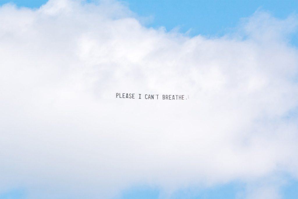 banner flying above Detroit, George Floyd Please I can't breathe