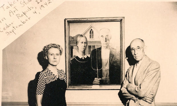 Nan Wood Graham and Byron McKeeby posing next to American Gothic.
