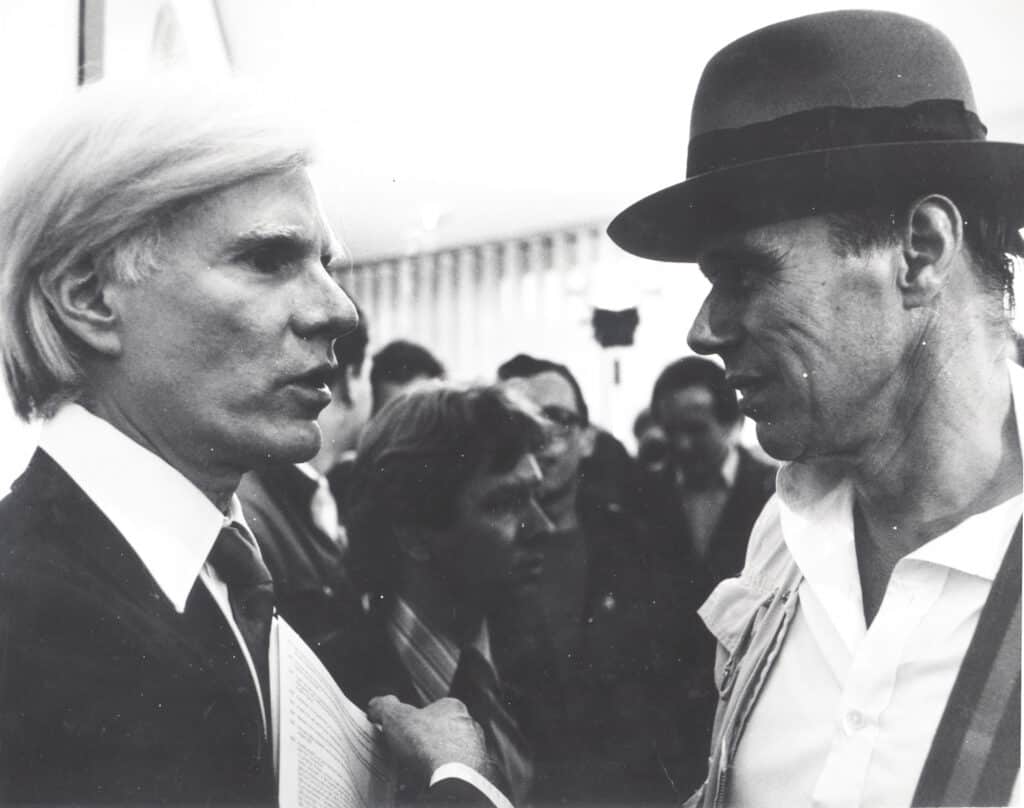 Joseph Beuys and Andy Warhol at Warhol's exhibition opening Indians, Portraits, Torsos on May 18, 1979 at the Galerie Hans Mayer. Photo: Werner Raeune. Courtesy of Beuys2021.