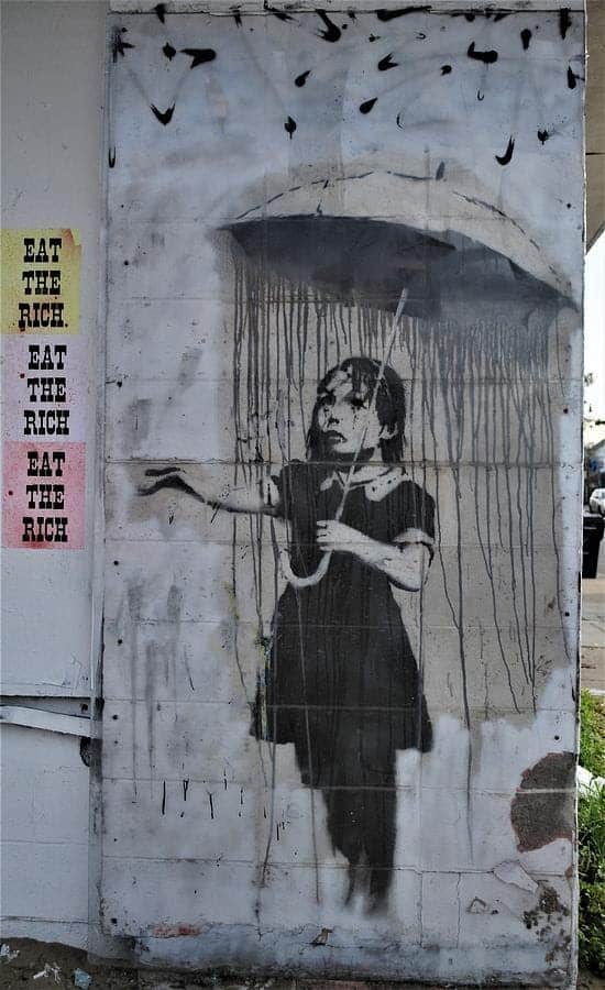Banksy, Umbrella Girl, street art in New Orleans.