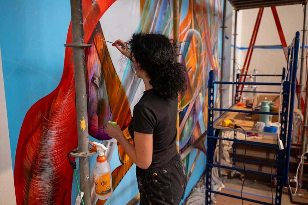 Nevena Prijic painting her mural 'Voyager'